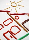 Plasticine cottage and sun Royalty Free Stock Photo