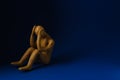 Plasticine figure of crying human on dark blue background. Space for text Royalty Free Stock Photo