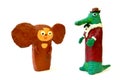 Plasticine figures the Cheburashka and Gena`s Crocodile on a white background. Children`s creativity