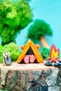 Plasticine landscape with a tent, a campfire and a backpack in the middle of the forest