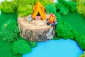 Plasticine landscape with a tent, a fire and a backpack on the lake