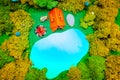 Plasticine landscape with a tent, a fire and a backpack on the lake