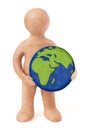 Plasticine man holding earth