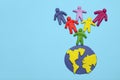 Plasticine multicolored cartoon people on globe. The use and depletion of the planet earth, overpopulation and population growth