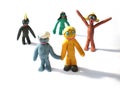 Plasticine people figures saying hi