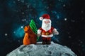 Plasticine Santa Claus with a bag of gifts and a Christmas tree on the moon