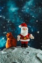 Plasticine Santa Claus with a bag of gifts on the moon