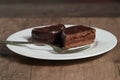 A plate with argentinean-uruguayan alfajores on a wooden table and dark background