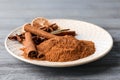 Plate with aromatic cinnamon sticks and powder Royalty Free Stock Photo