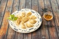 Plate of Asian boiled gyoza with sweet and sour sauce