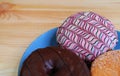 Plate of assorted doughnuts on wooden table