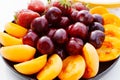 A plate with assorted fruits and berries on the table. Royalty Free Stock Photo