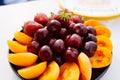 A plate with assorted fruits and berries on the table. Royalty Free Stock Photo