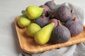 Plate with assorted ripe figs on table