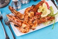 Plate with assorted sea grill for beer. Fried king prawns with lemon, mussels with oyster sauce, Colmar rings, crab meat Royalty Free Stock Photo