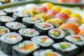 A plate with assorted sushi rolls displayed on a table, A plate of colorful sushi rolls arranged neatly Royalty Free Stock Photo