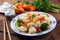 plate of authentic chinese cuisine, with steamed dumplings and stir-fried vegetables