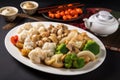 plate of authentic chinese cuisine, with steamed dumplings and stir-fried vegetables