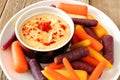 Plate of baby rainbow carrots with hummus close up Royalty Free Stock Photo