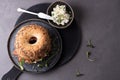 Plate with bagel with cream cheese, dry cured ham and microgreens on a gray background, delicious snack concept Royalty Free Stock Photo