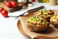 Plate of baked potatoes with cheese and bacon on table, closeup. Royalty Free Stock Photo