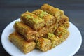 Plate of Baklava Pastries with Pistachio Nuts Served on Wooden table Royalty Free Stock Photo