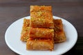 Baklava Pastries Topped with Chopped Pistachio Nuts on Dark Brown Wooden Table Royalty Free Stock Photo