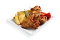 Plate with barbecued chicken wings and garnish Royalty Free Stock Photo