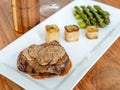 Plate of a beef dish on blurred sparrow grass background Royalty Free Stock Photo