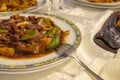 Plate of beef with peppers, vegetables and hot sauce served in a Chinese restaurant Royalty Free Stock Photo