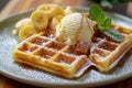 A plate of Belgian waffles, paired with a scoop of vanilla ice cream and caramelized bananas. Royalty Free Stock Photo