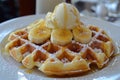 A plate of Belgian waffles, paired with a scoop of vanilla ice cream and caramelized bananas. Royalty Free Stock Photo