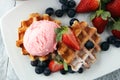 Plate of belgian waffles with strawberry ice cream, and fresh st Royalty Free Stock Photo