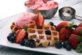 Plate of belgian waffles with strawberry ice cream, and fresh st Royalty Free Stock Photo