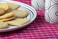 Plate of biscuits and cups on a red napkin