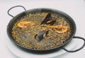 plate of black rice paella with squid, shrimp and mussels Royalty Free Stock Photo