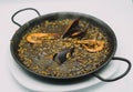 plate of black rice paella with squid, shrimp and mussels Royalty Free Stock Photo