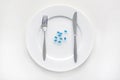 Plate and blue diet pills