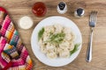 Plate with boiled dumpling, napkin, pepper, salt, mayonnaise, ketchup