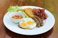 plate with boiled rice egg and sausage, fry shrimp, bacon vegetables