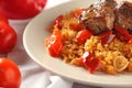 Plate with boiled rice, meat and sweet pepper on table, closeup Royalty Free Stock Photo