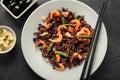 Plate with boiled rice, shrimps and vegetables on dark table Royalty Free Stock Photo