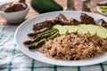 Plate with boiled rice, vegetables and meat on table Royalty Free Stock Photo