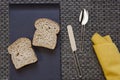 Plate with bread and napkin spoon knife on warp background Royalty Free Stock Photo