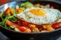 A plate of breakfast food with a fried egg on top, ready to eat Royalty Free Stock Photo