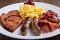 Plate of breakfast - scrambled eggs, bacon, sausage and ham 1