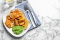 Plate with British traditional fish and potato chips on marble background, top view. Royalty Free Stock Photo