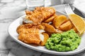 Plate with British traditional fish and potato chips on marble table Royalty Free Stock Photo