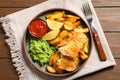 Plate with British traditional fish and potato chips on wooden background Royalty Free Stock Photo