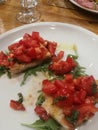 Plate of bruschetta with tomato, basil, oil and garlic